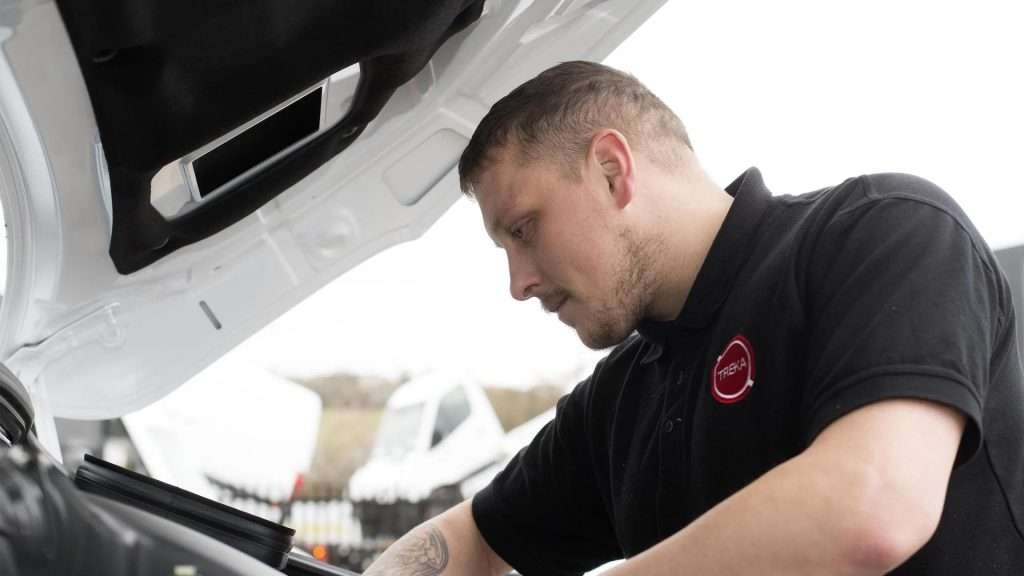 A maintenance technician inspecting an engine bay